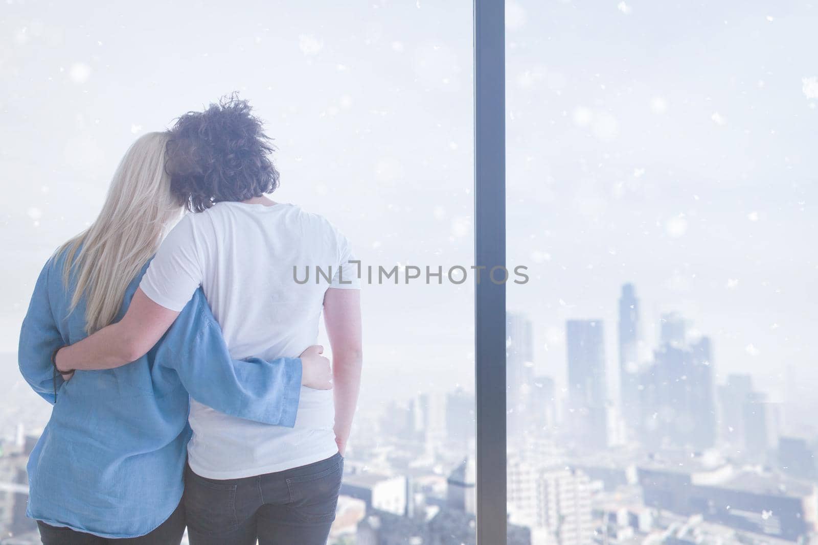 romantic happy young couple enjoying morning coffee by the window on cold winter day at home