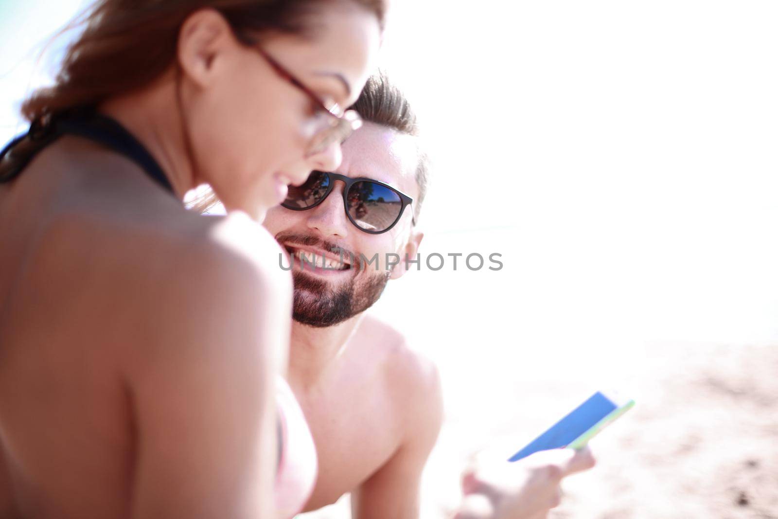 Happy couple spending carefree time on the beach outdoors. by asdf