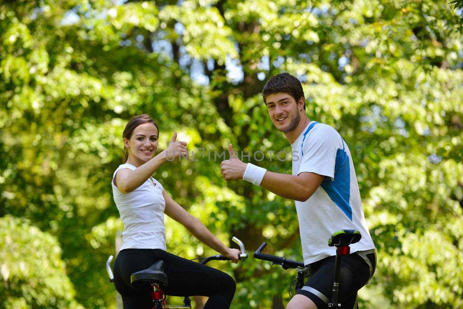 Happy couple ride bicycle outdoors, health lifestyle fun love romance concept