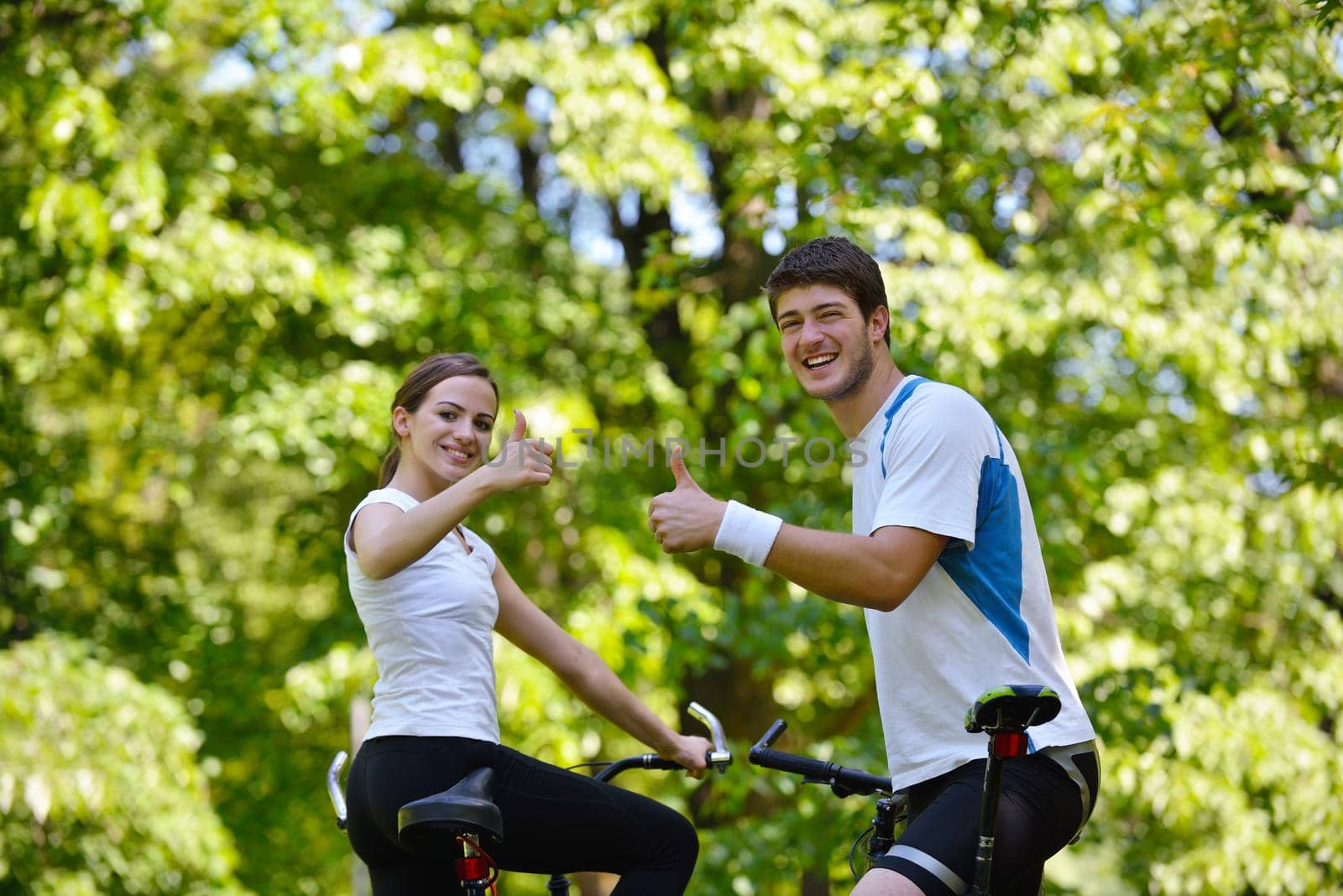 Happy couple ride bicycle outdoors, health lifestyle fun love romance concept