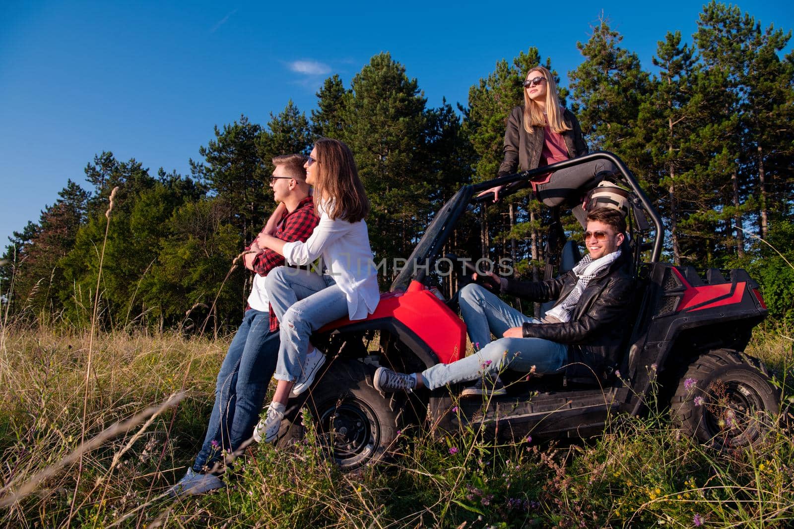 group of young people driving a off road buggy car by dotshock