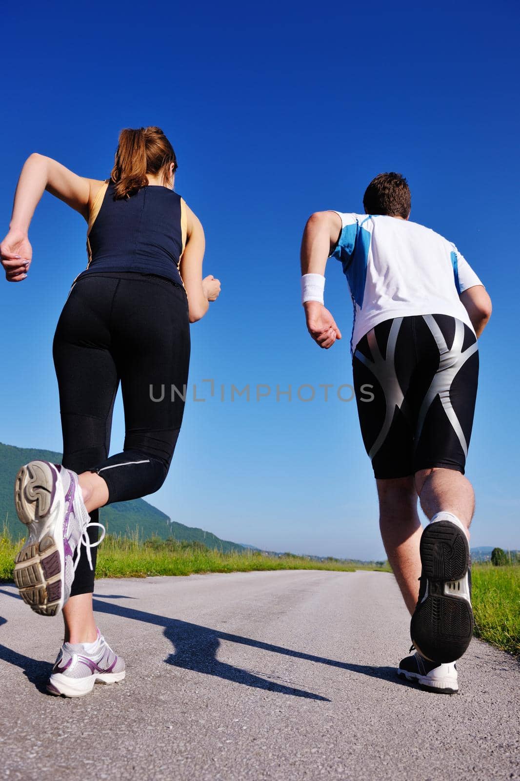 Young couple jogging by dotshock