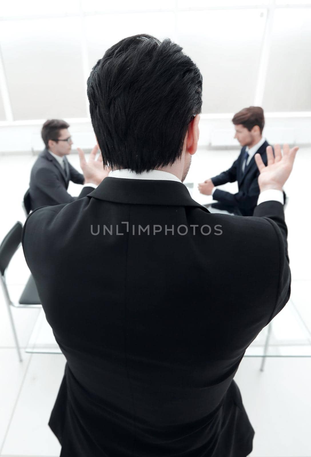 rear view.businessman holds a working meeting. by asdf