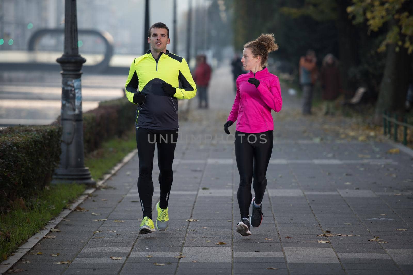 young  couple jogging by dotshock
