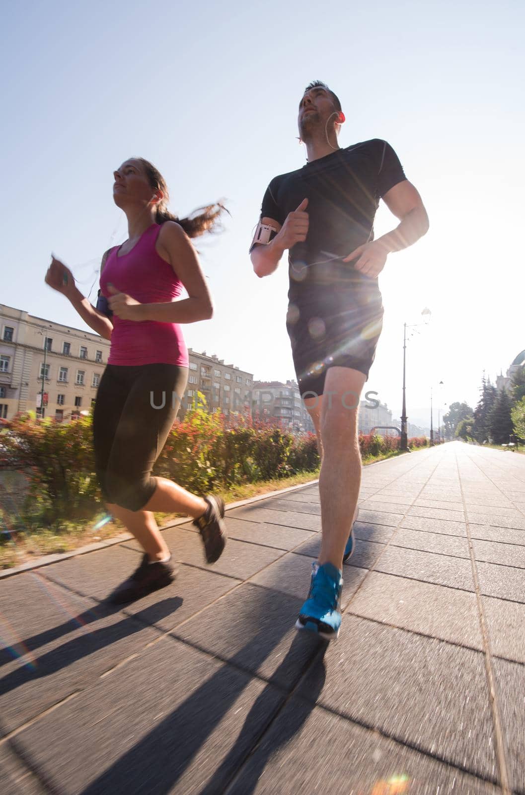 urban sports, healthy young couple jogging  in the city at sunny morning