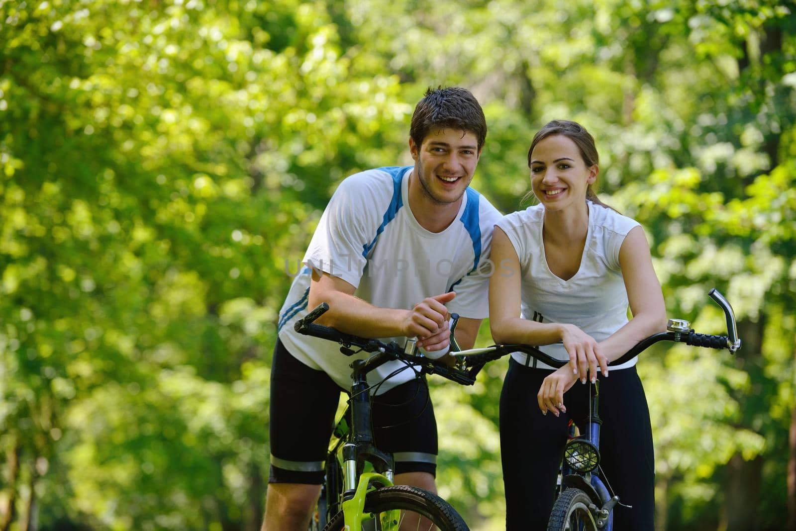 Happy couple ride bicycle outdoors, health lifestyle fun love romance concept