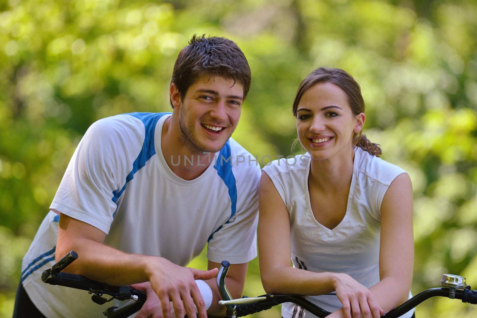 Happy couple ride bicycle outdoors, health lifestyle fun love romance concept