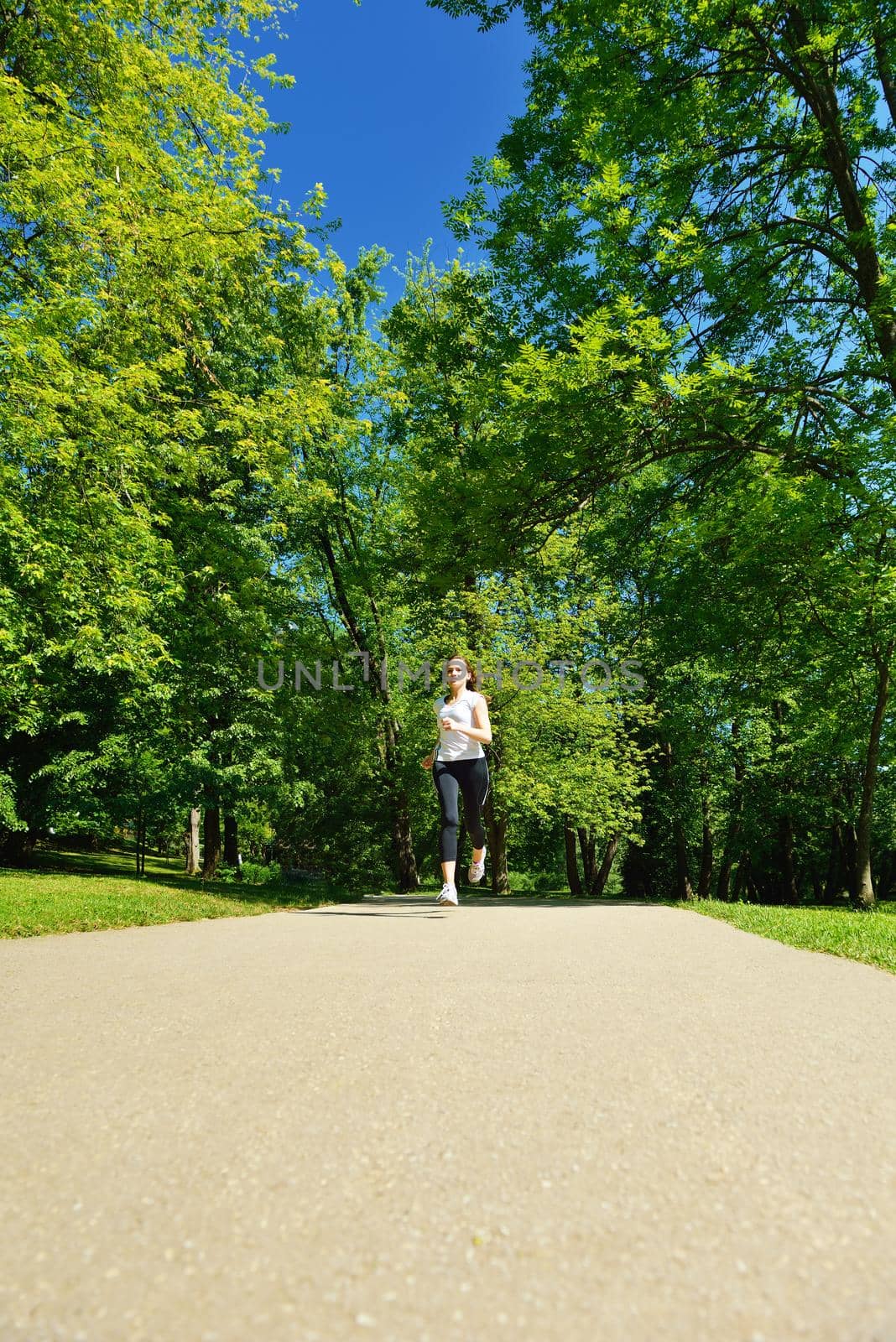 Young beautiful  woman jogging at morning in park by dotshock