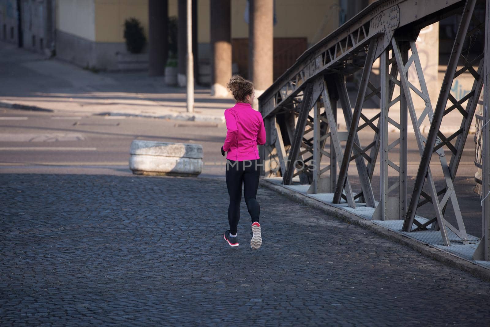 sporty woman jogging on morning by dotshock