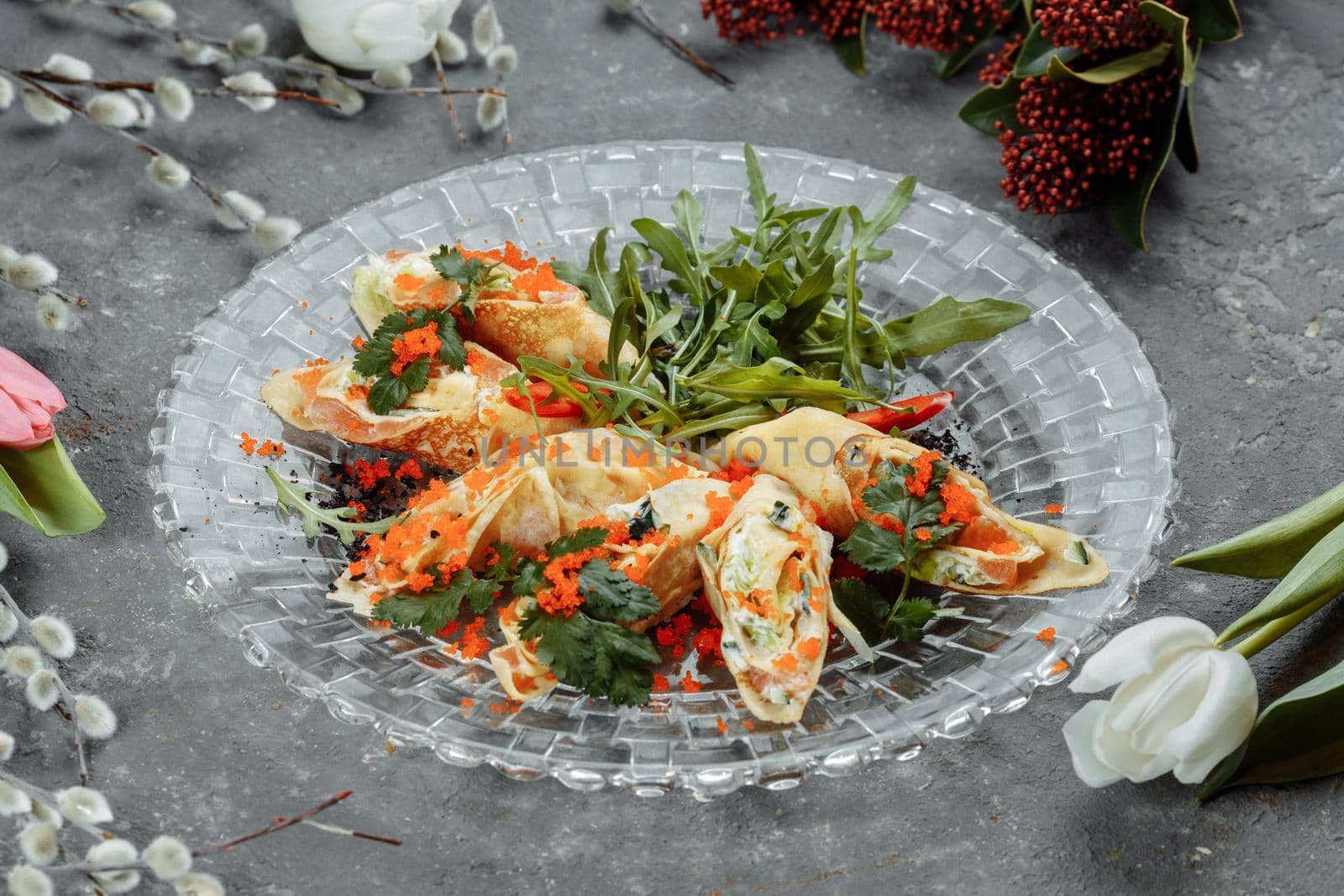 thin pancakes with caviar and salmon, rolled into rolls.