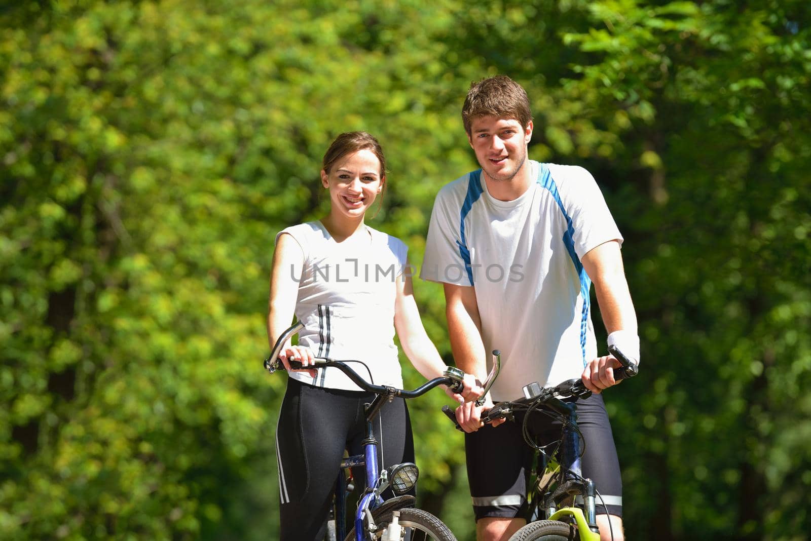 Happy couple ride bicycle outdoors, health lifestyle fun love romance concept