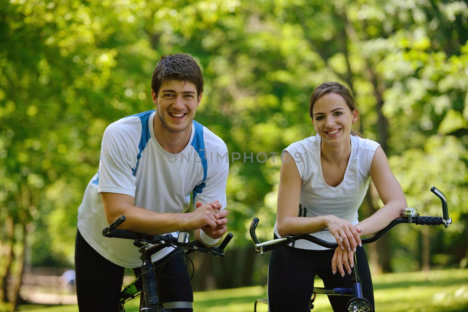 Happy couple ride bicycle outdoors, health lifestyle fun love romance concept