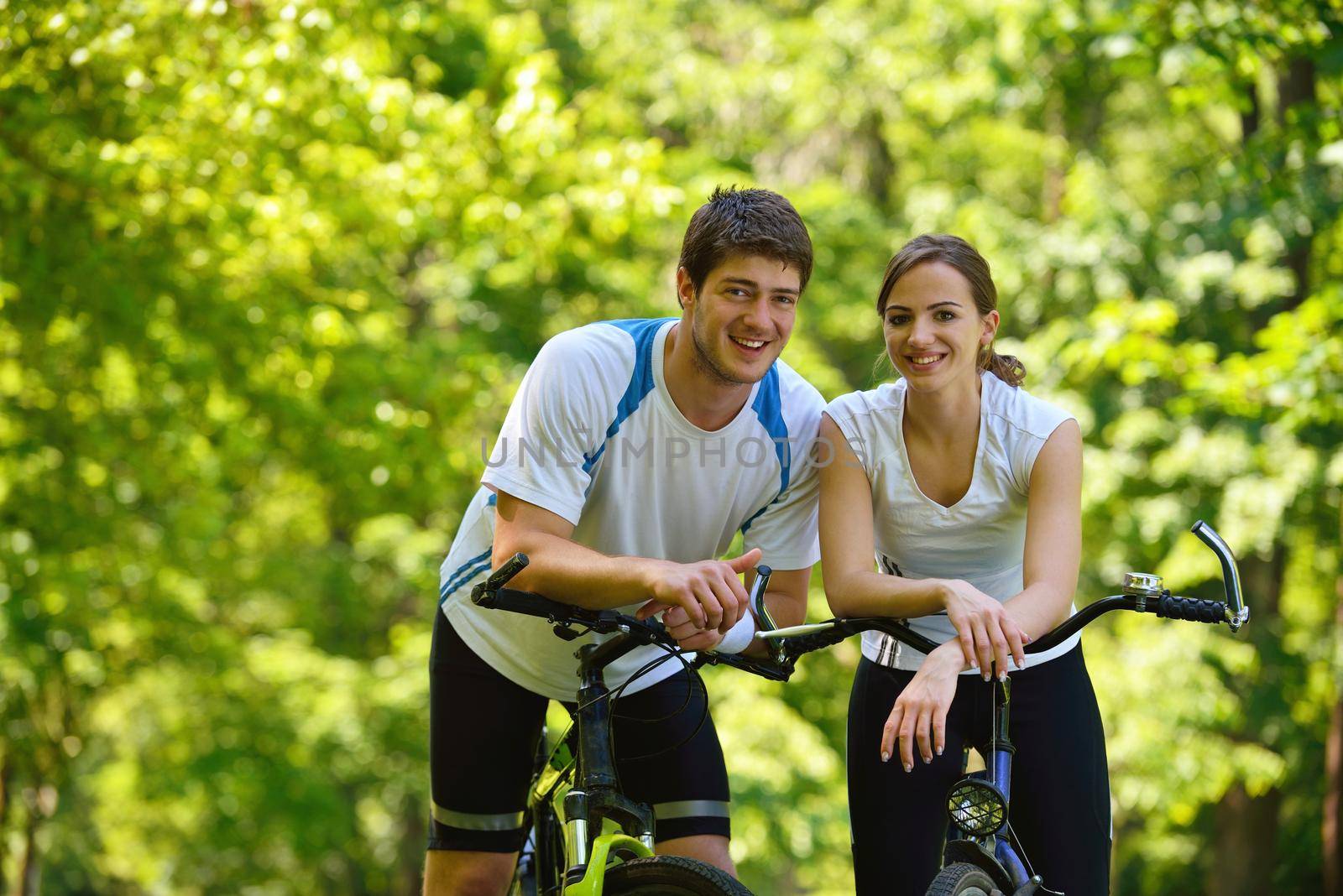 Happy couple ride bicycle outdoors, health lifestyle fun love romance concept