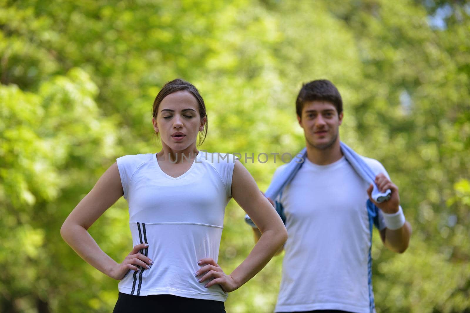 Couple doing stretching exercise  after jogging by dotshock