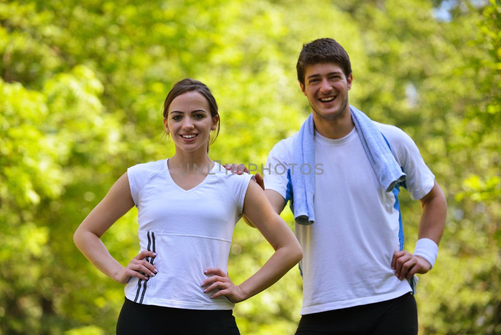 young health couple doing stretching exercise relaxing and warm up after jogging and running in park