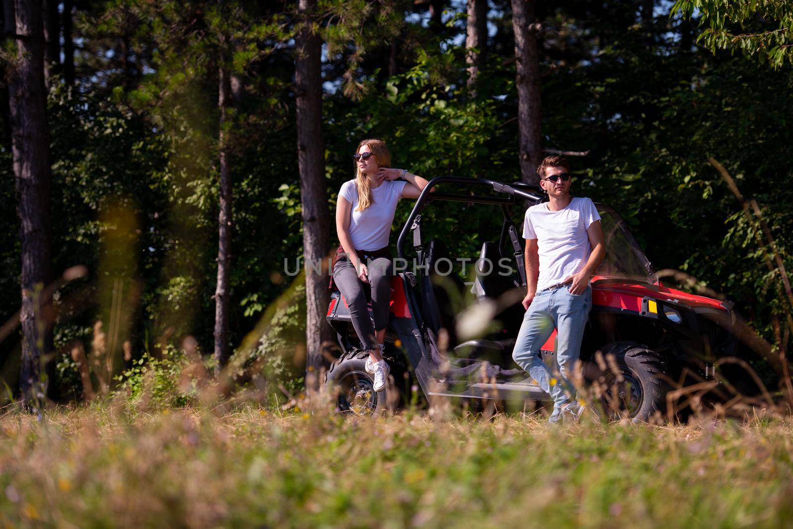 young couple driving a off road buggy car by dotshock
