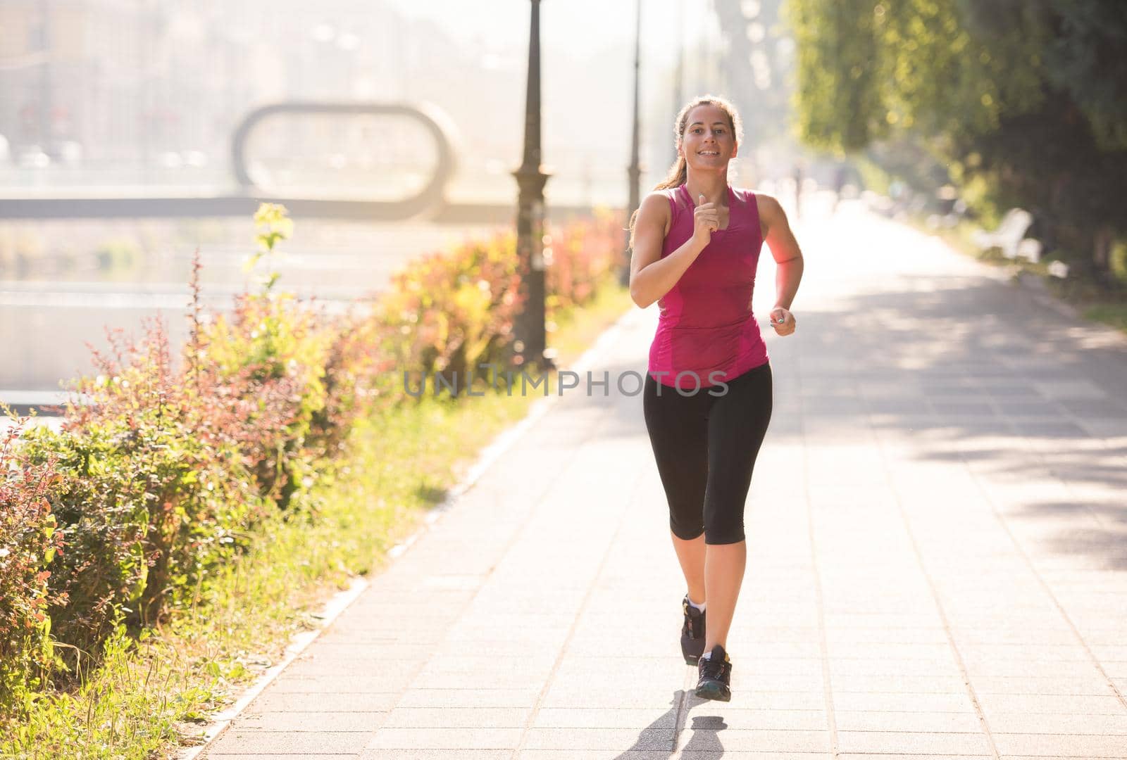 woman jogging at sunny morning by dotshock