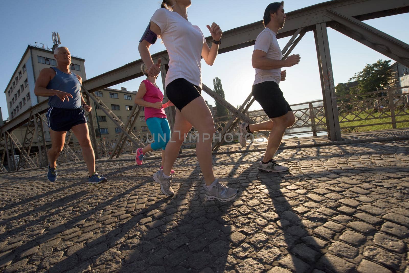 people group jogging  runners team on morning  training workout with sunrise in background