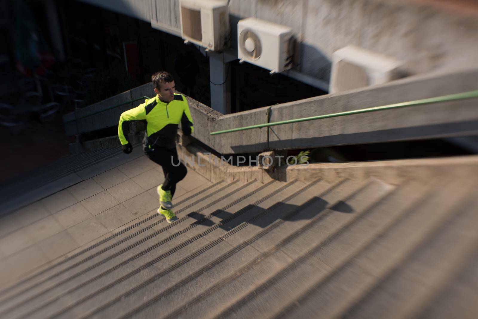 man jogging  at cold autumn  mornigng on steps