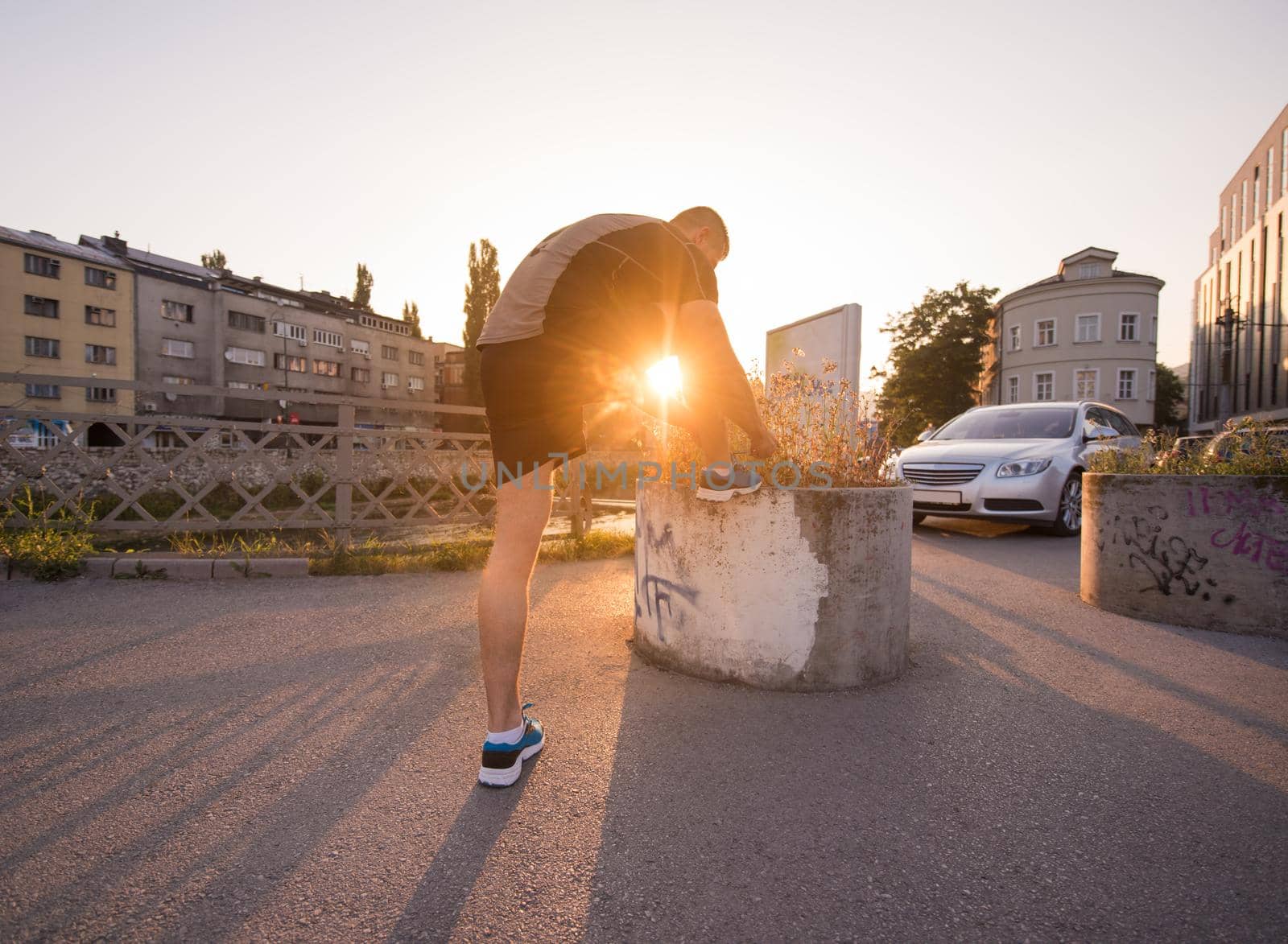 man tying running shoes laces by dotshock