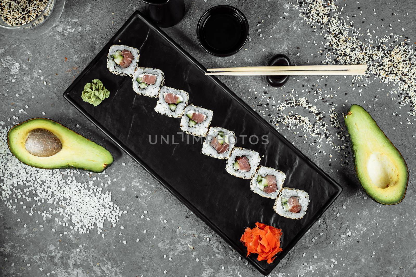 California roll sushi traditional Japanese rice food with salmon, avocado, cucumber, nori and sesame seeds by UcheaD