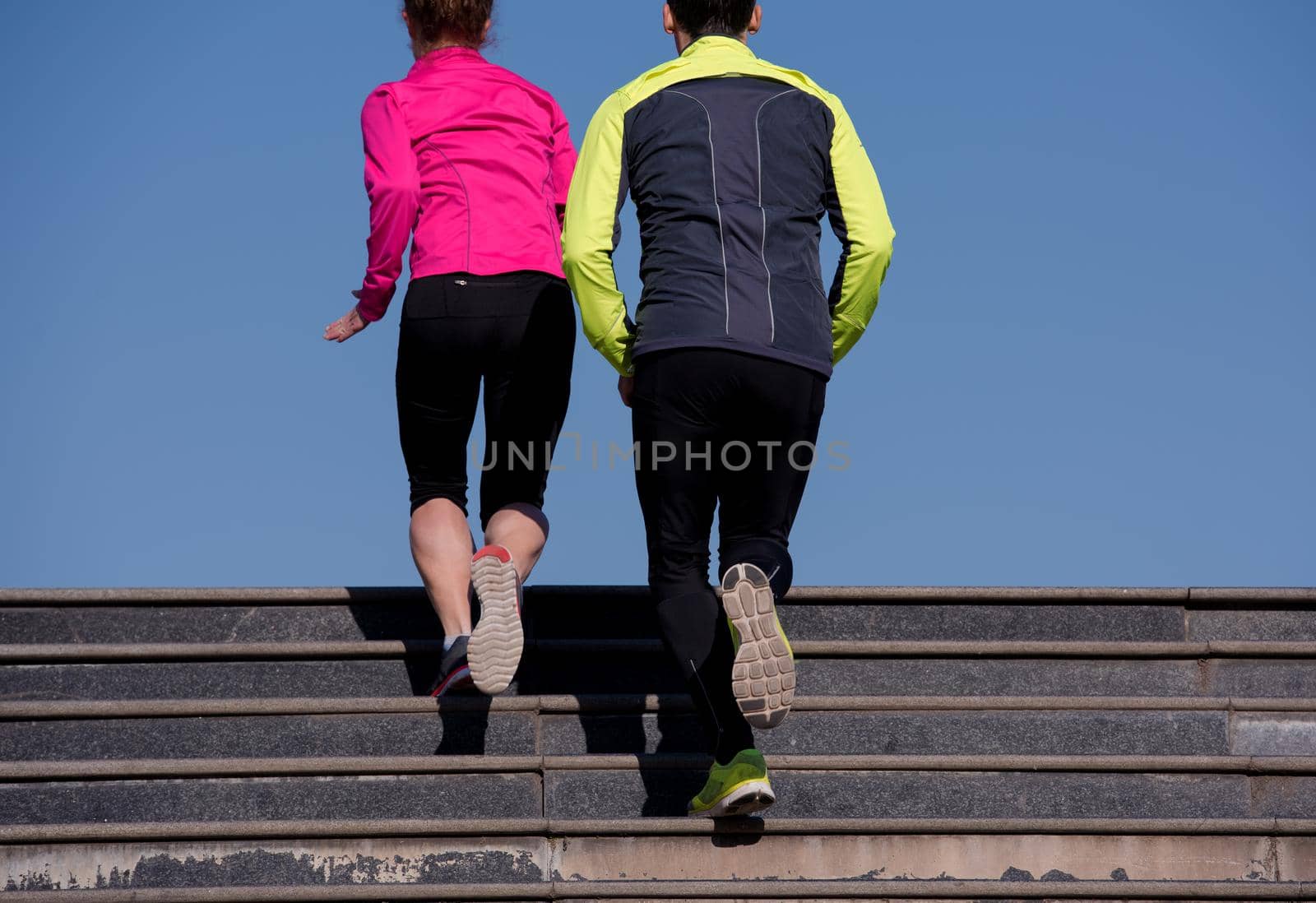 young  couple jogging on steps by dotshock
