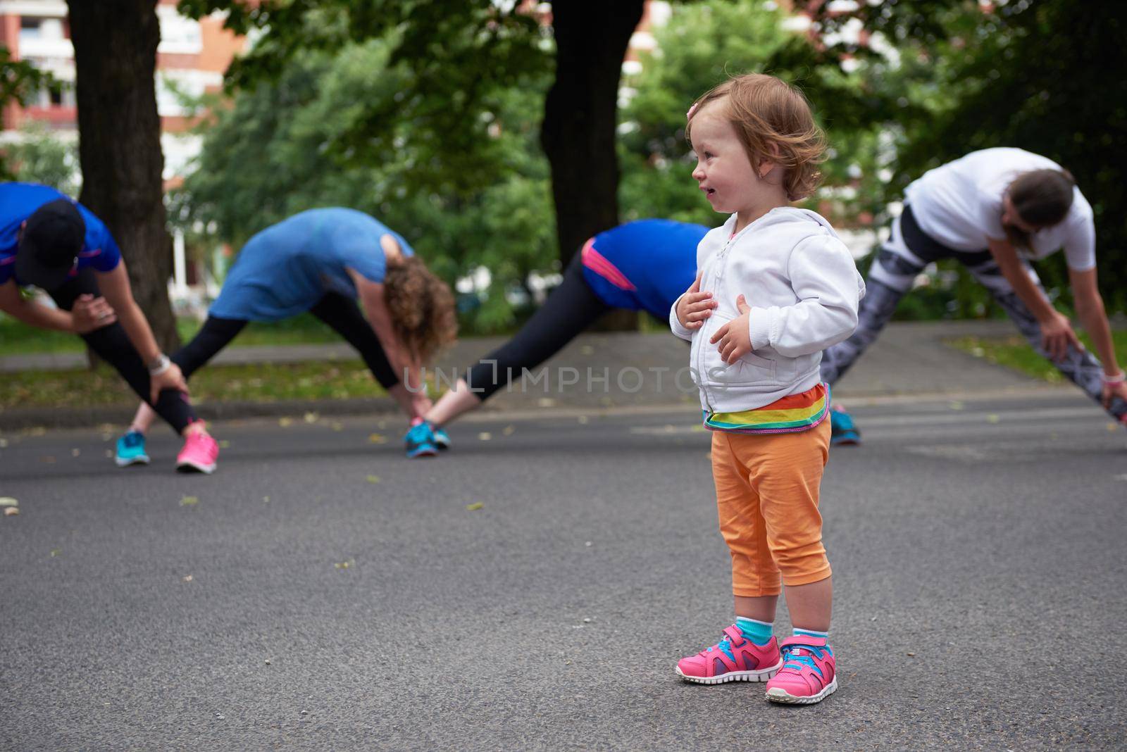 jogging people group have fun with baby girl by dotshock