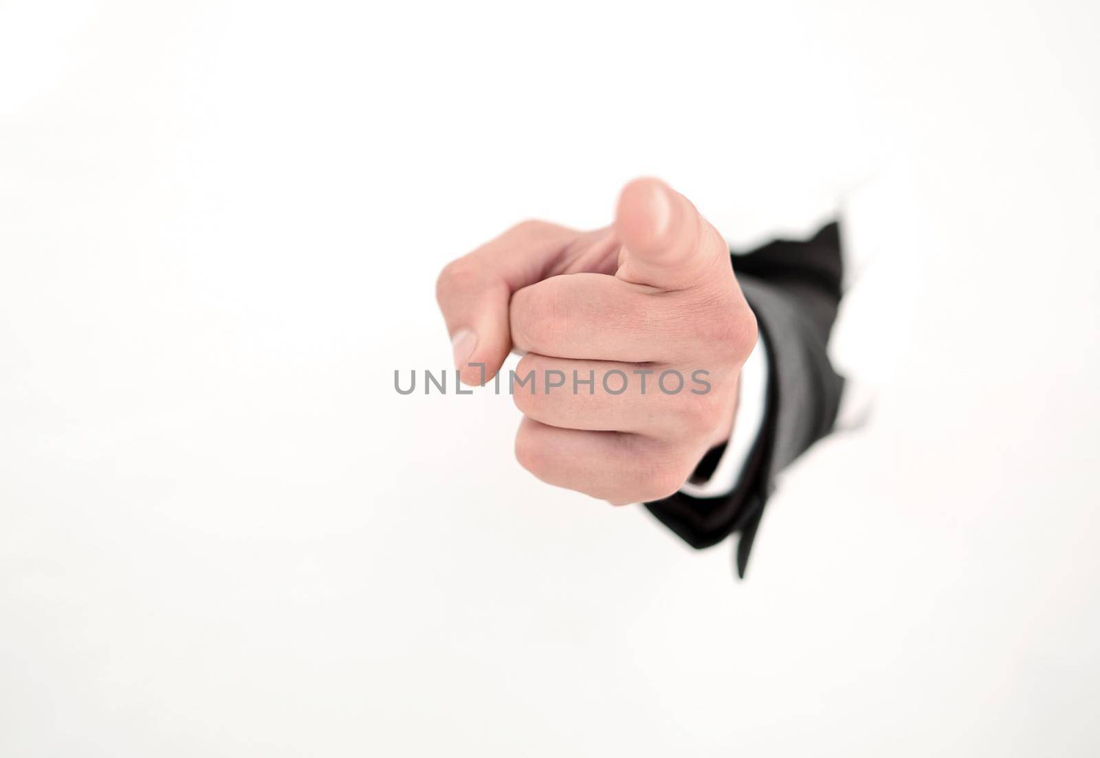businessman breaking through the paper wall and pointing at you.photo with copy space