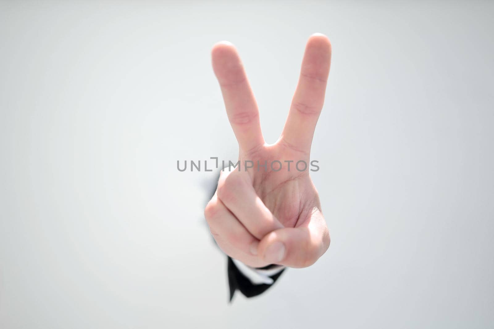close up. businessman showing a gesture of victory.photo with copy space