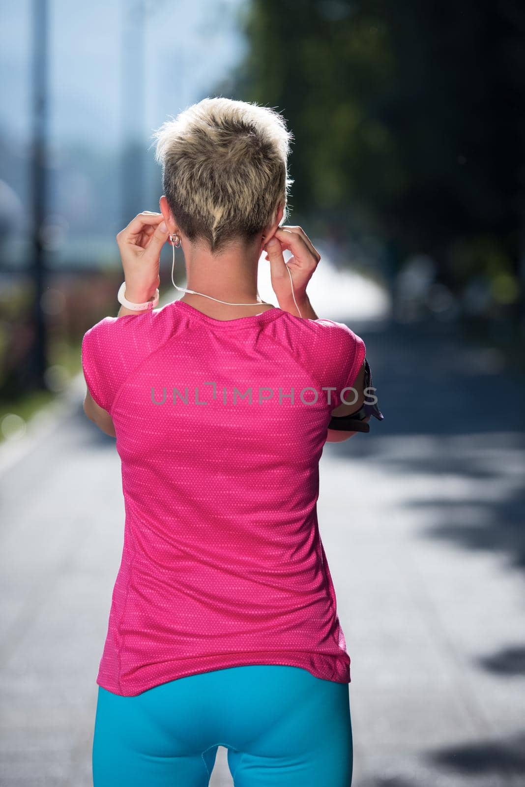 jogging woman setting phone before jogging by dotshock