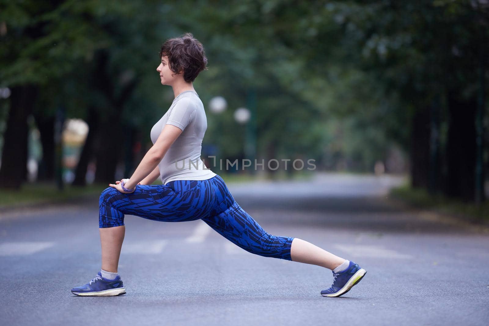woman  stretching before morning jogging by dotshock
