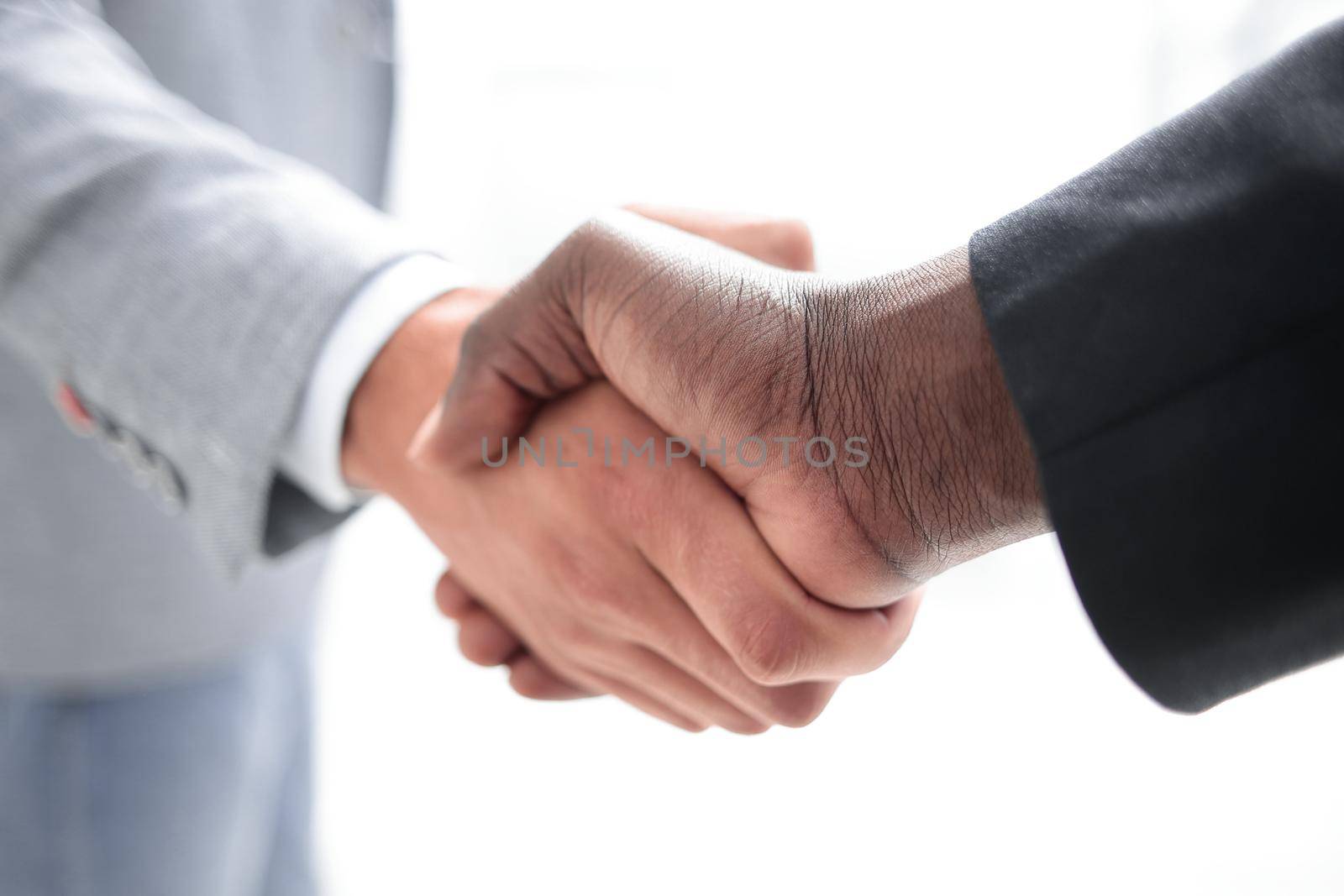 Business people closing a deal and handshaking at the office