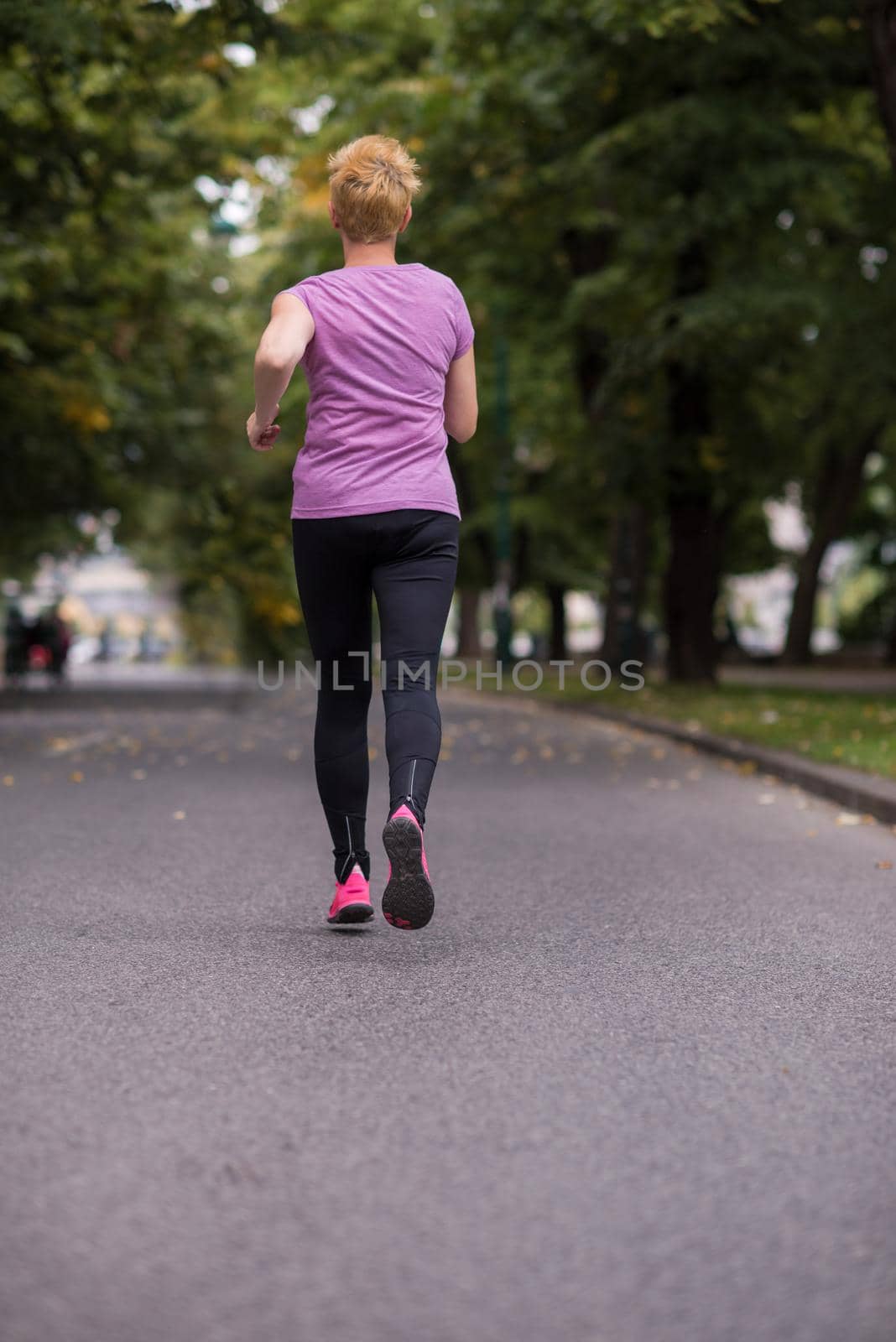 sporty female runner training for marathon by dotshock