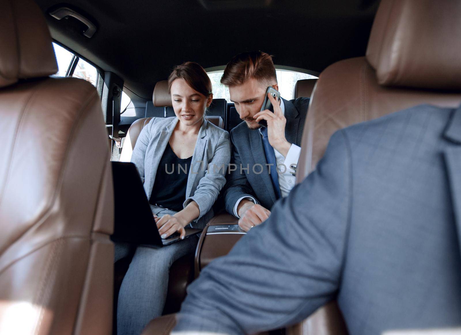 business colleagues working in the car by asdf