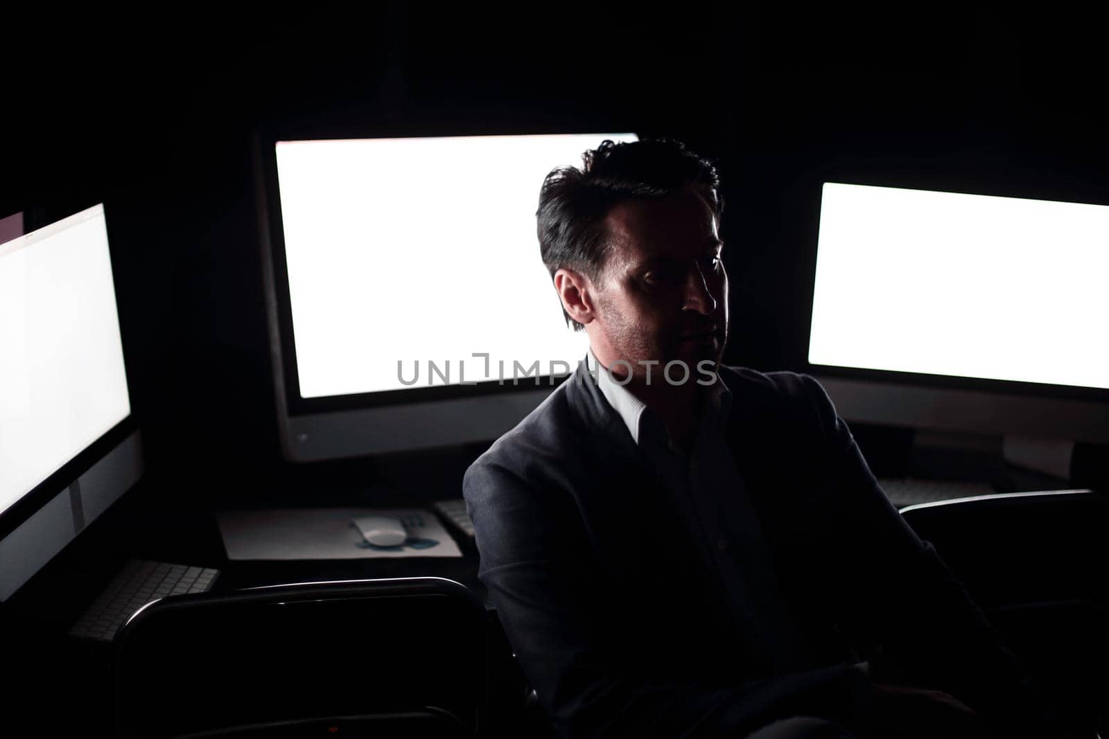 tired businessman working in the computer room late.people and technology