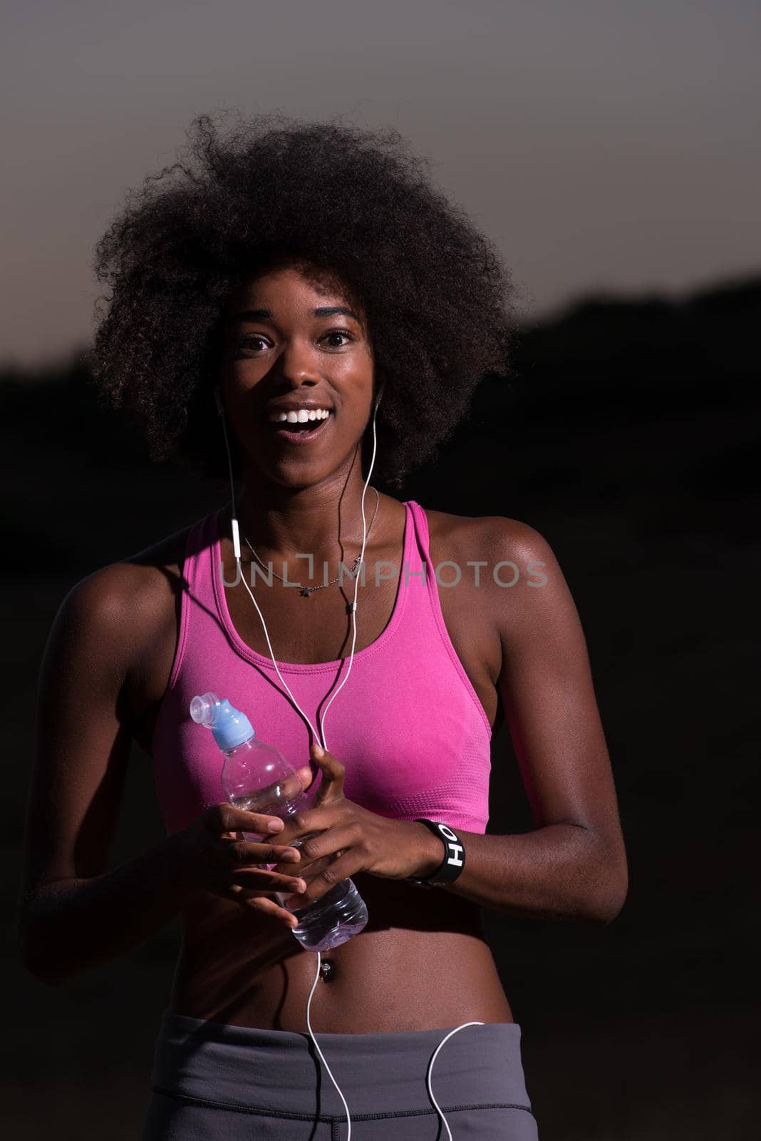african american woman jogging in nature by dotshock