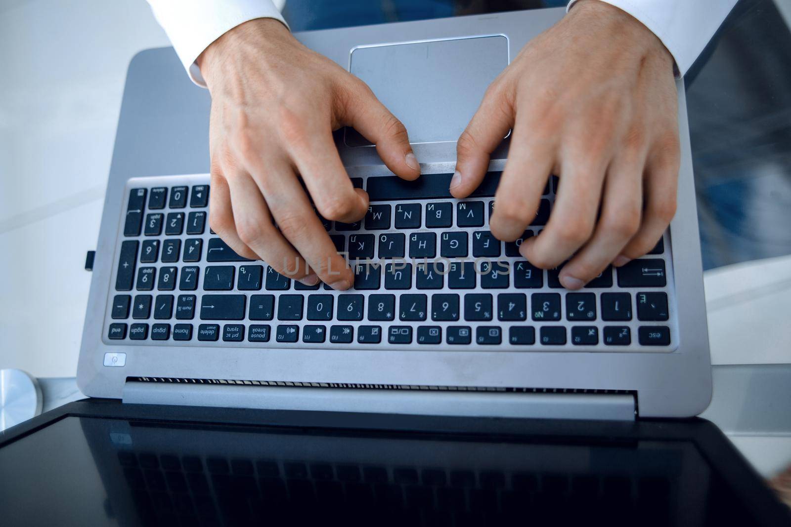Close-up of male hands typing on laptop.people and technology