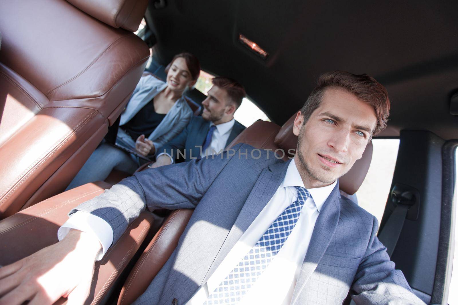 group of business people in a luxury car.people and technology