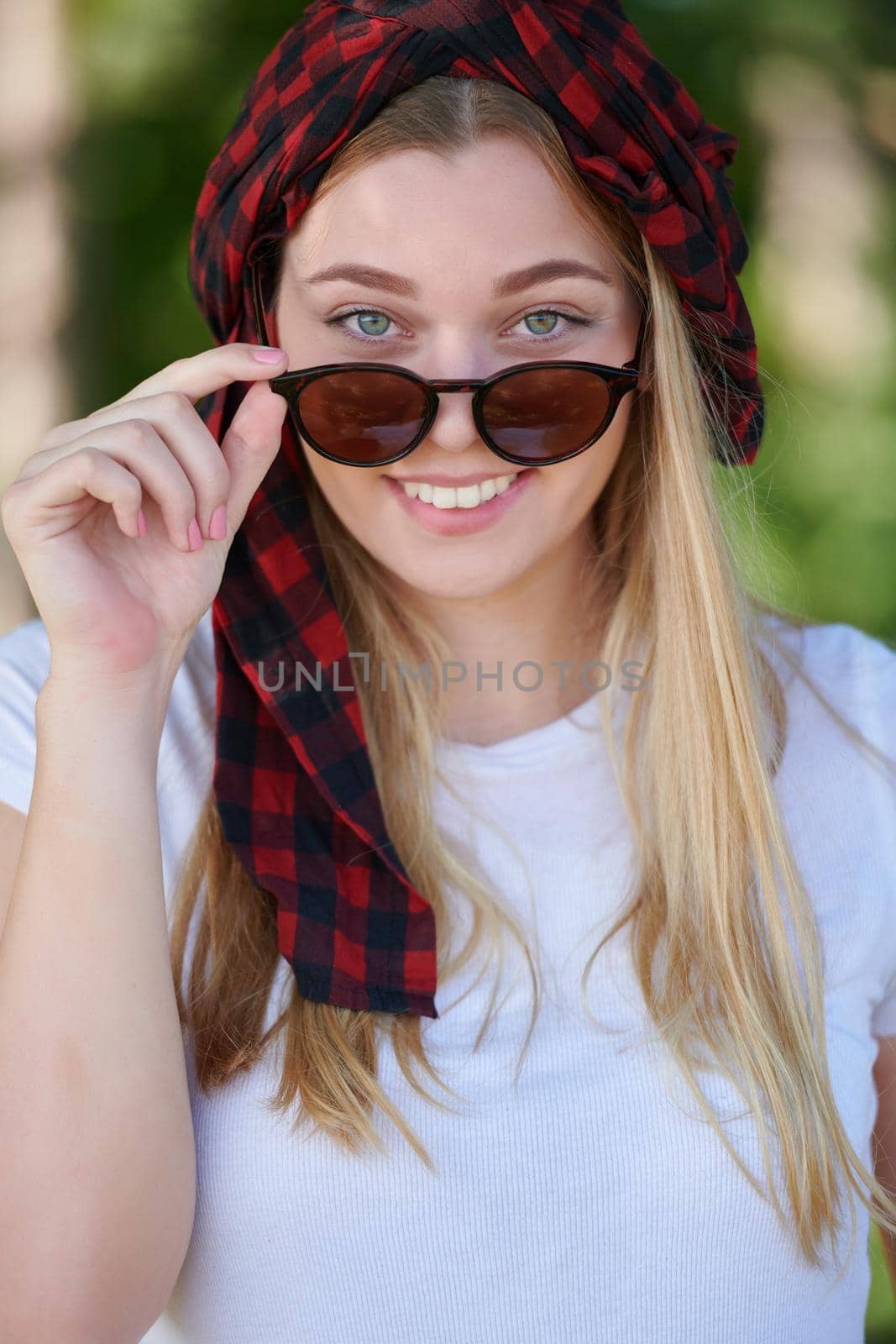 Outdoor portrait of beautiful, emotional, young woman in sunglasses. Soft background. Copy space