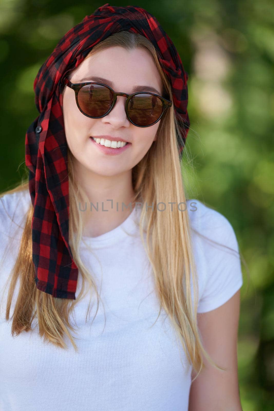 Outdoor portrait of beautiful, emotional, young woman in sunglasses. Soft background. Copy space