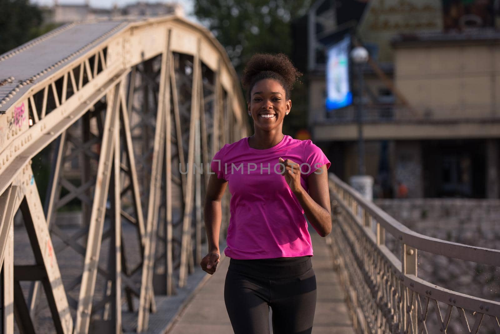 african american woman running across the bridge by dotshock
