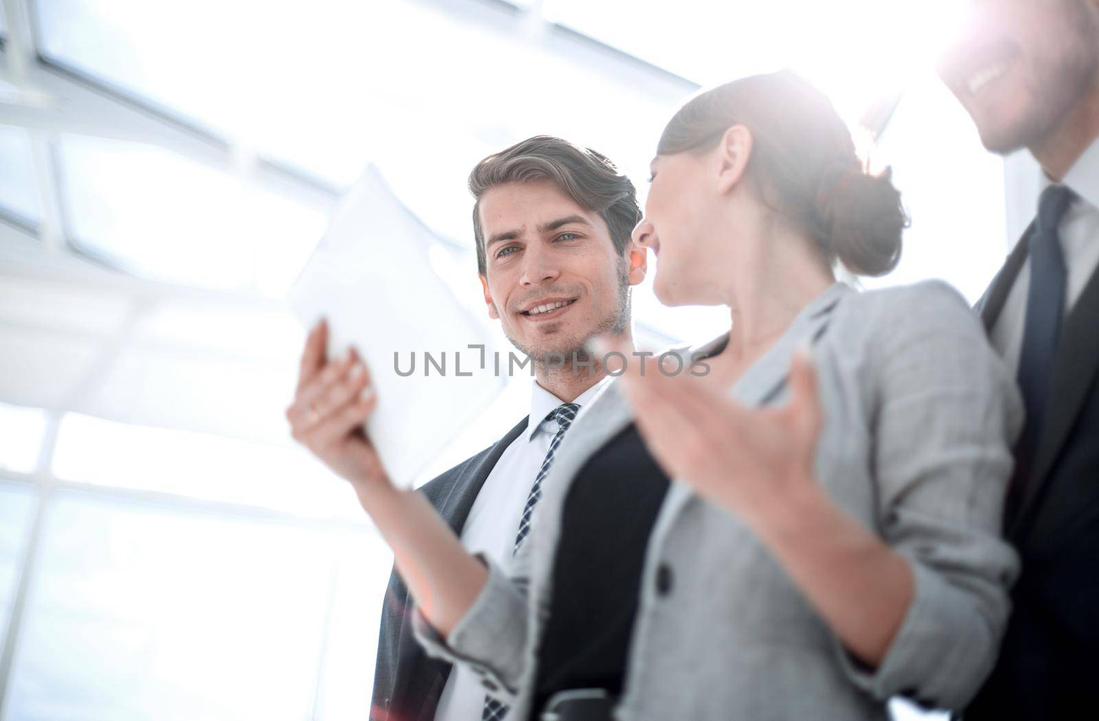 close up.young employees with a digital tablet. by asdf