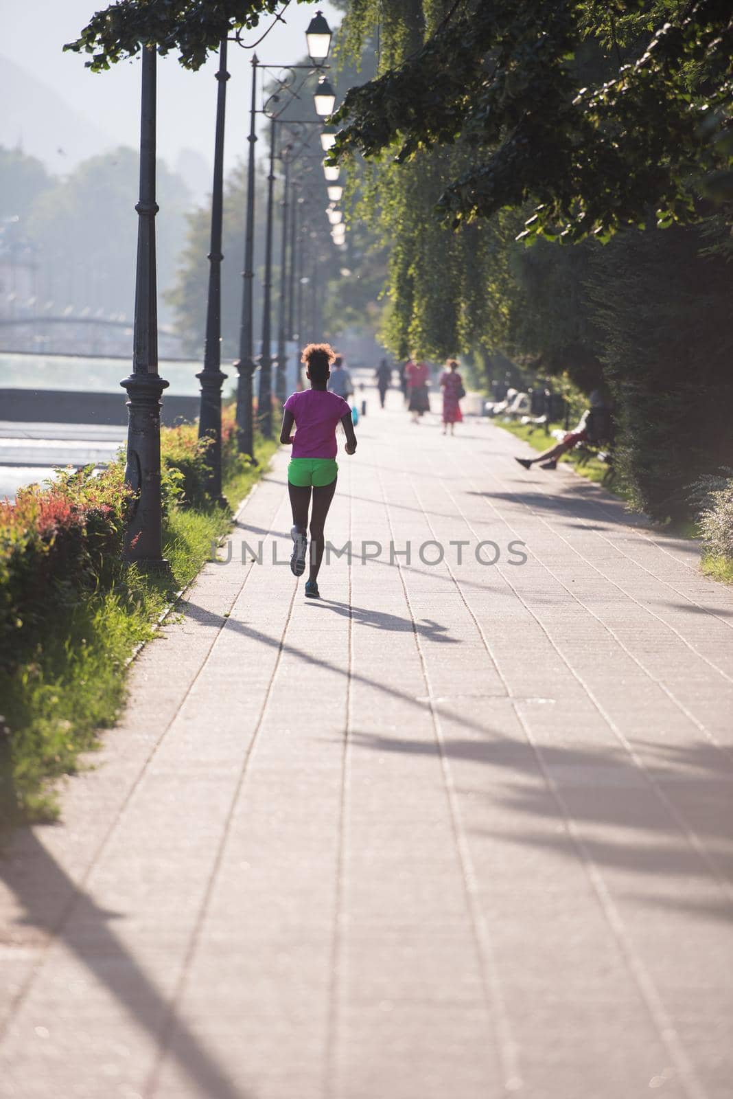 african american woman jogging in the city by dotshock