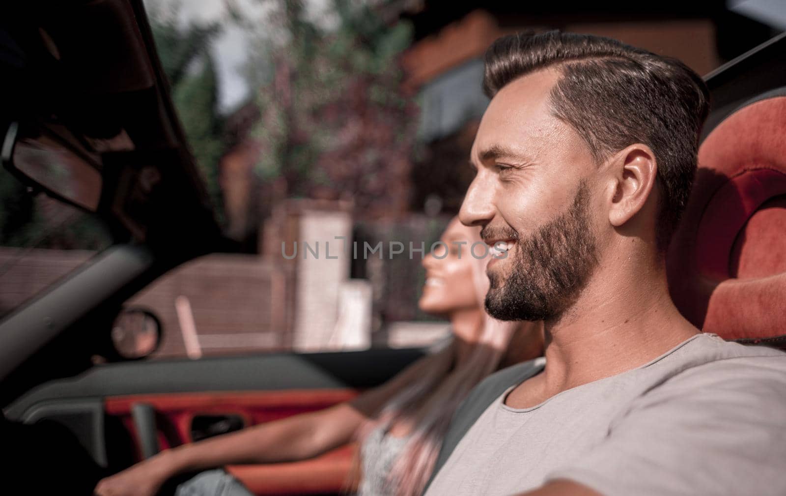 close up.handsome man driving a convertible car.the concept of a successful lifestyle