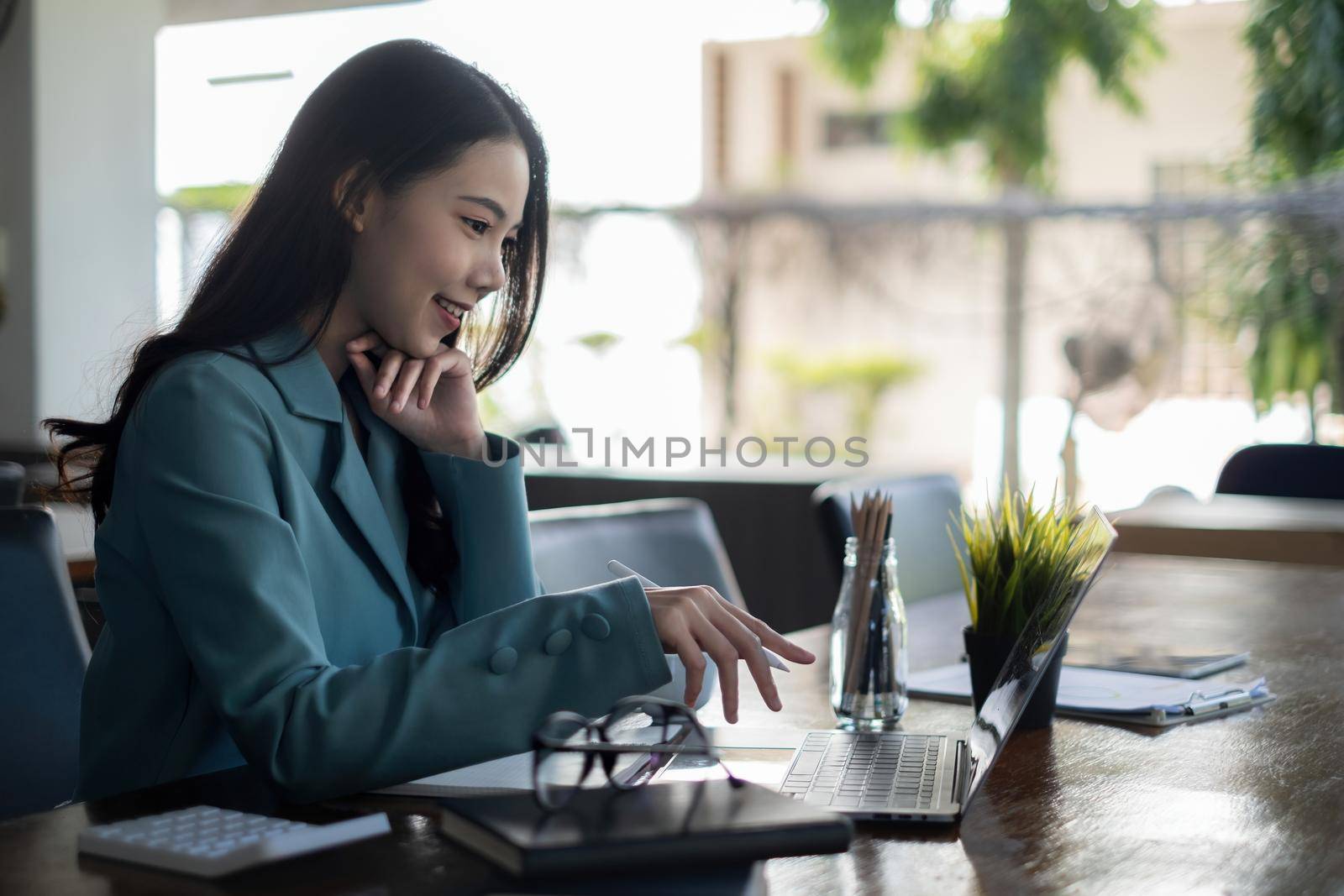 Asian business woman using laptop talk to colleagues for briefing business plan in video call. finance fund investment concept