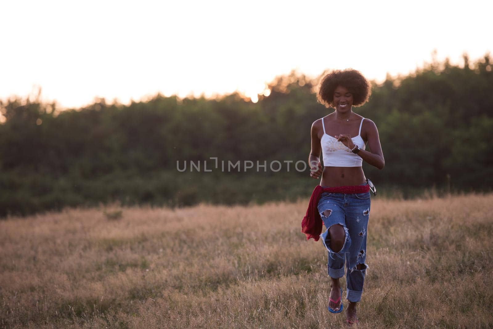 Healthy Looking Smiling Young African American Female beautiful summer evening in nature