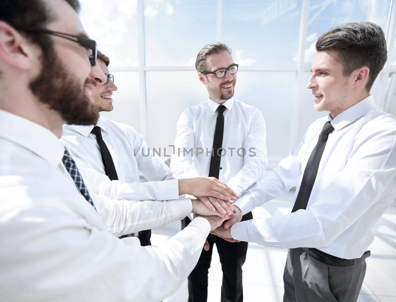 successful business team put their hands together. by asdf