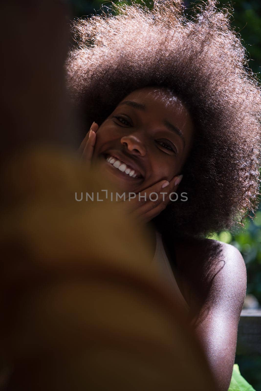 Close up portrait of a beautiful young african american woman smiling and looking up by dotshock