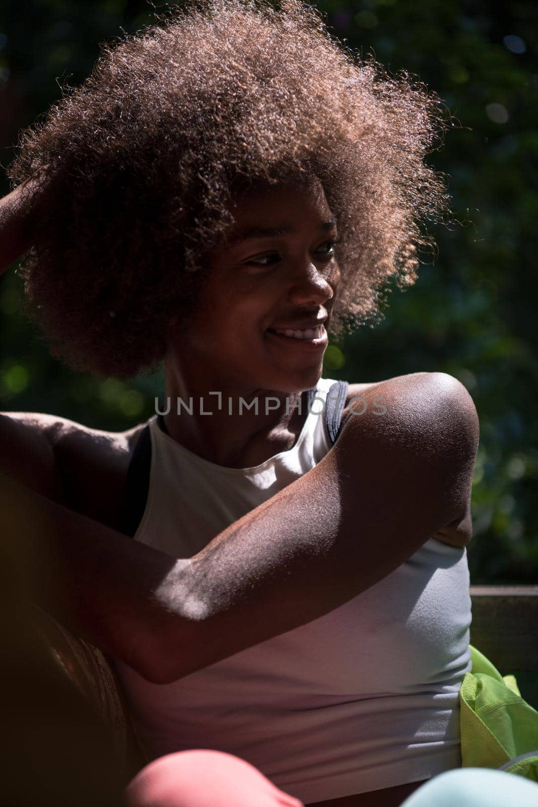 Close up portrait of a beautiful young african american woman smiling and looking up on a beautiful sunny day