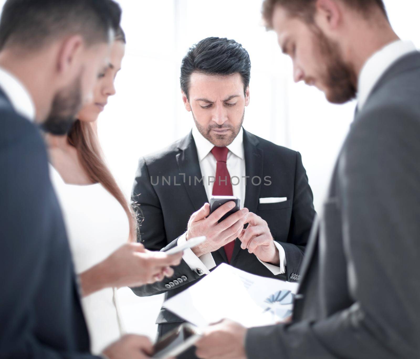 businessman using a smartphone at a meeting in the office by asdf